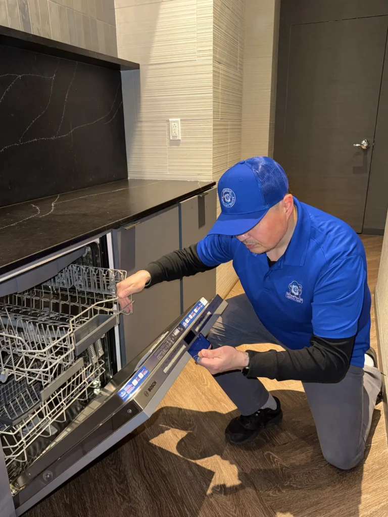 Appliance repair technician fixing dishwasher